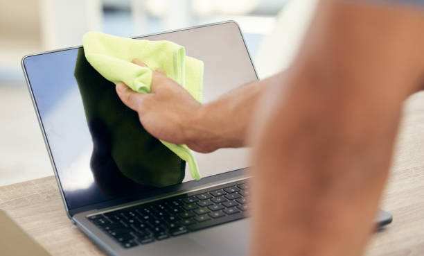 person cleaning monitor screen correctly