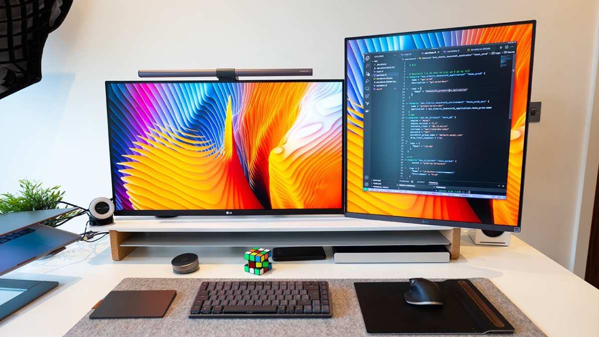 student coding with external monitor
