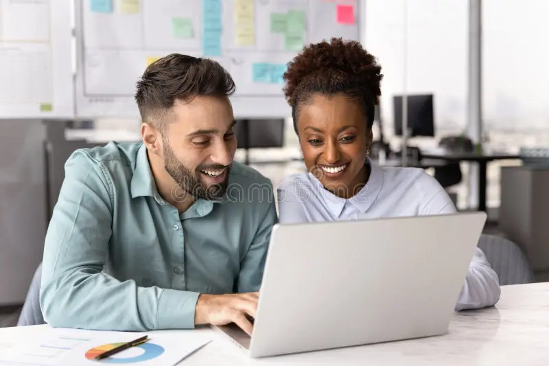 two people discussing at computer