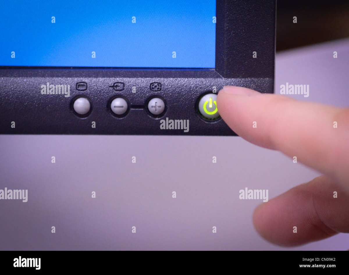hand pressing monitor button